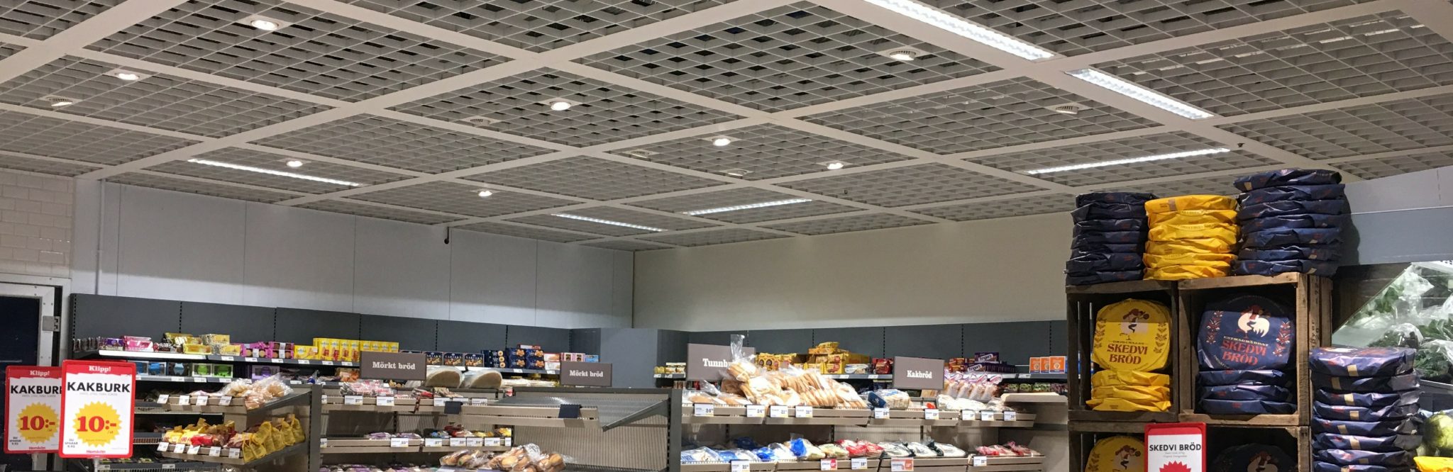 Pendelarmatur för dagligvaruhandel - FLOW. Här med transparent skärm.